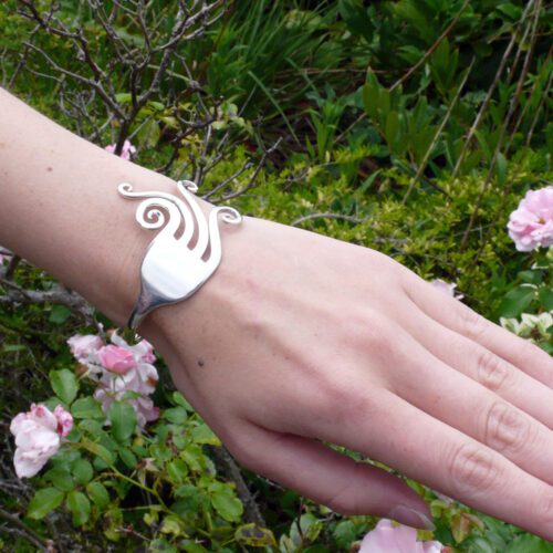 Handcrafted and recycled swirls fork bangle worn
