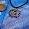 Handcrafted and recycled big wave surfer coin pendant necklace