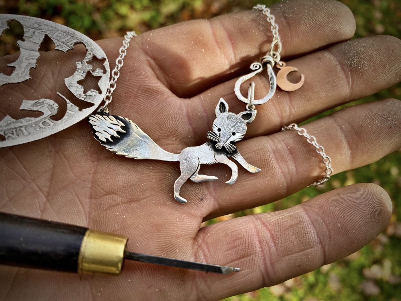 Handcrafted and recycled silver curious fox necklace made from silver coins