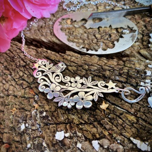 bird and blossom flower necklace made from ethical recycled silver half crown coins. Sterling silver handmade jewellery