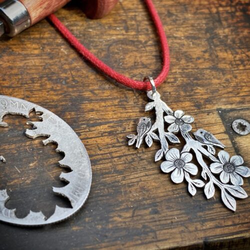 beckoning the seed moon bird on brach silver necklace pendant