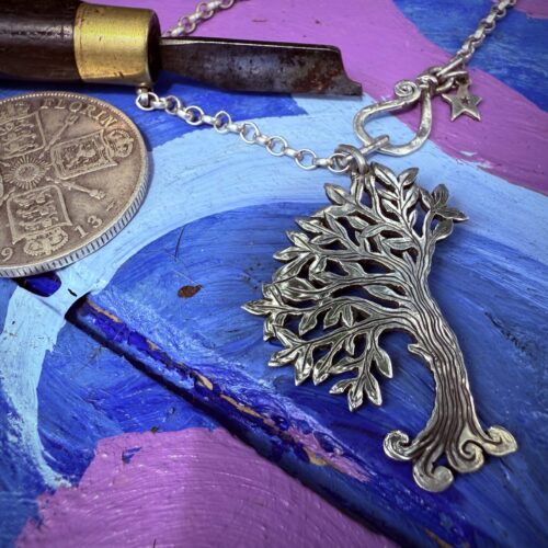 Handcrafted and recycled silver wind blown tree made from a silver coin in the workshop, Cambridge