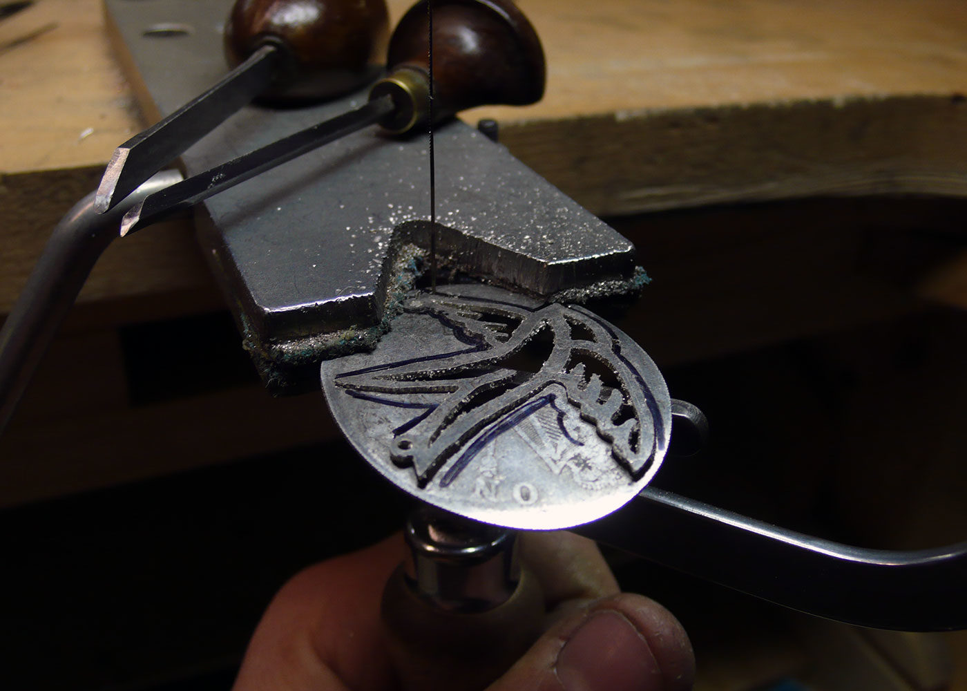 Handcrafted sterling silver freedom and love necklace being made in the workshop