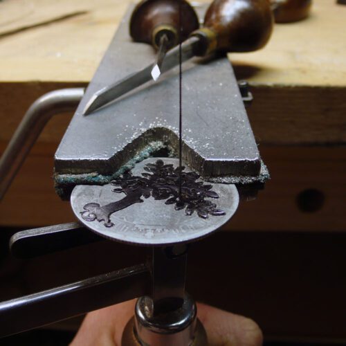 Handcrafted and recycled silver spring tree made from a silver coin in the workshop, Cambridge