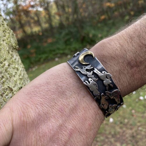 Handcrafted and recycled silver kuff bracelet leaping and dashing hares