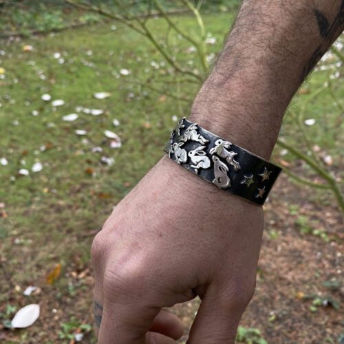 Handcrafted and recycled silver kuff bracelet leaping and dashing hares