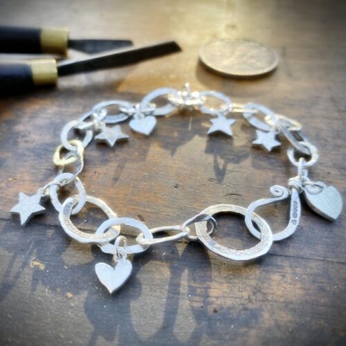 Personalised initials, hearts and stars bracelet individually handcrafted and recycled from an old Victorian silver coins and recycled ethical gold