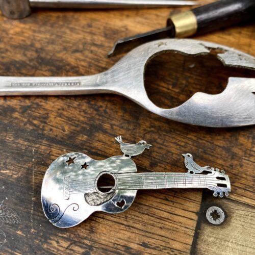 handcrafted and recycled spoon bird and guitar brooch