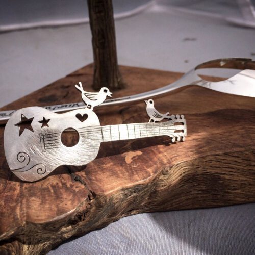 handcrafted and recycled spoon bird and guitar brooch
