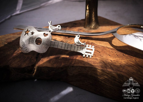handcrafted and recycled spoon bird and guitar brooch