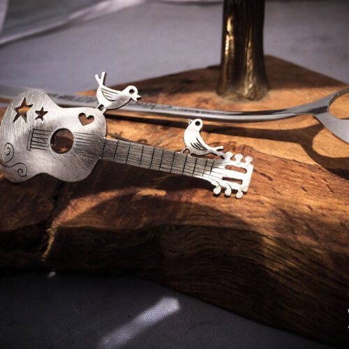 handcrafted and recycled spoon bird and guitar brooch