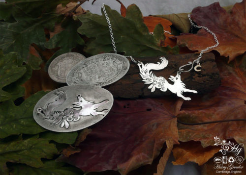 Handcrafted and recycled sterling silver leaping fox and dancing vixen necklace being cut out of the silver coin