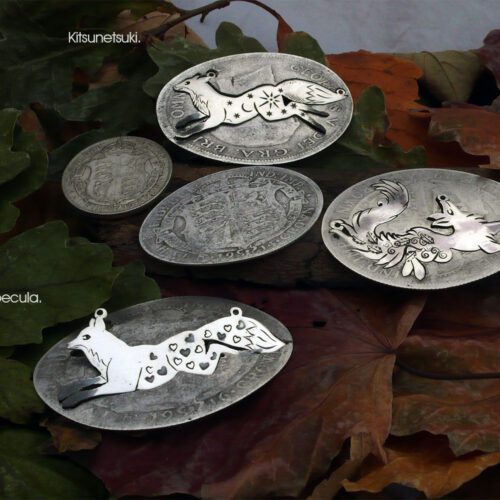 Handcrafted and recycled sterling silver leaping fox and dancing vixen necklace being cut out of the silver coin