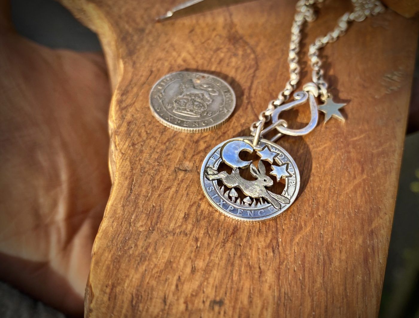 Handcrafted and recycled silver sixpence coin leaping hare pendant necklace