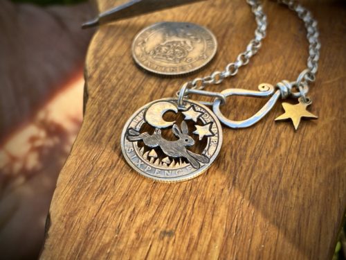 Handcrafted and recycled silver sixpence coin leaping hare pendant necklace