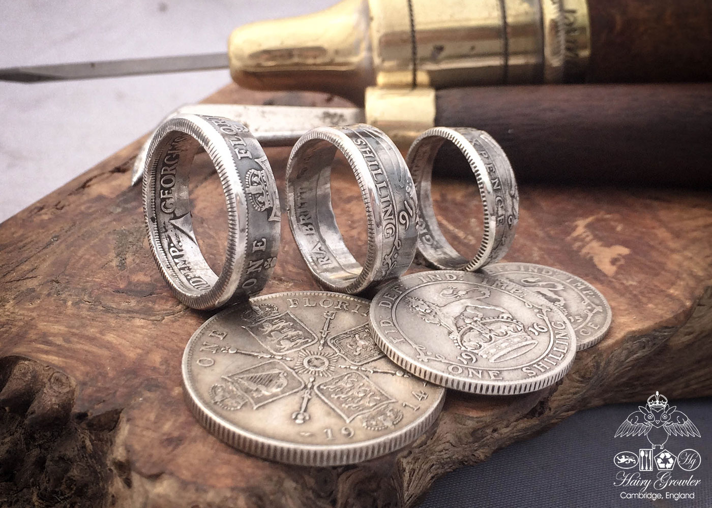 Handmade and recycled silver coin rings being sized in the workshop