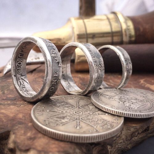 Handmade and recycled silver coin rings being sized in the workshop