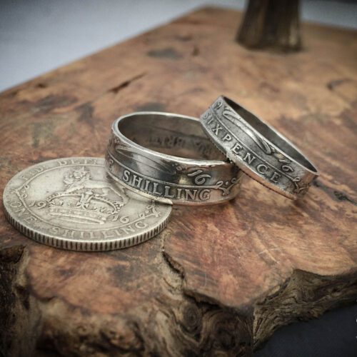 Handmade and recycled silver coin rings being sized in the workshop