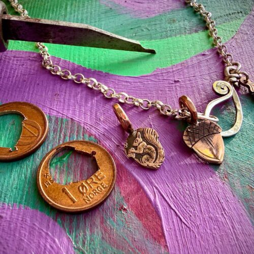 handmade and recycled copper acorn pendant made from Norwegian coin with squirrel on reverse side 1 øre