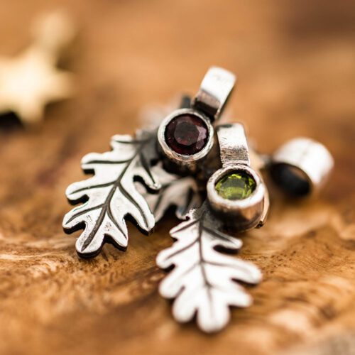 handcrafted silver and peridot and garnet oak leaf charm for a tree sculpture, necklace or bracelet