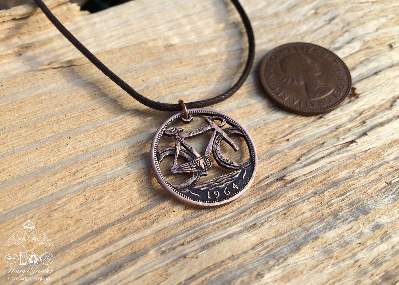 Handcrafted and recycled coin fixed speed bicycle pendant necklace.