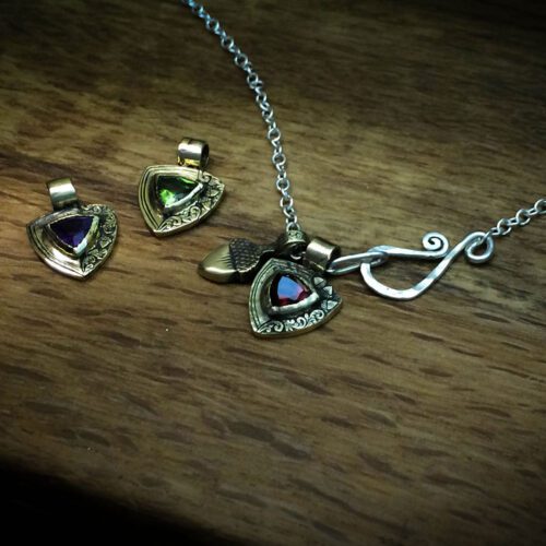 handcrafted bronze and peridot family shield for a tree sculpture, necklace or bracelet