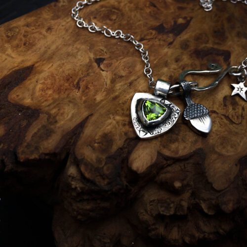handcrafted silver and peridot family shield for a tree sculpture, necklace or bracelet