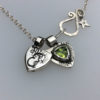handcrafted silver and peridot family shield for a tree sculpture, necklace or bracelet