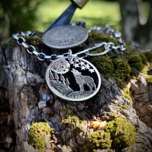 Handcrafted and recycled silver shilling The Silver Shilling collection. silver wolves necklace totally handcrafted and recycled from old sterling silver shilling coins. Designed and created by Hairy Growler Jewellery, Cambridge, UK. necklace