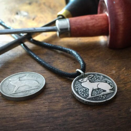 hand carved flourish Irish hare threepence coin pendant with hand carved massage on the edge
