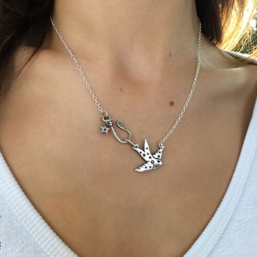 Swallow necklace handcrafted and recycled coin jewellery made from a silver Florin coin. Ethical jewellery made in an artisan workshop