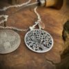 Tree of life silver coin necklace handcrafted and recycled ethical jewellery created at an artisan jewellery studio workshop in Cambridge, England. Eco-conscious, green and eco-friendly jewellery.