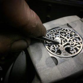 Tree of life silver coin necklace handcrafted and recycled ethical jewellery created at an artisan jewellery studio workshop in Cambridge, England. Eco-conscious, green and eco-friendly jewellery.