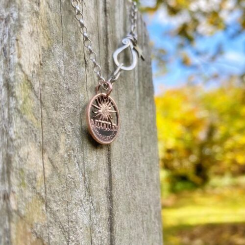 handmade and upcycled summer solstice Stonehenge coin necklace pendant