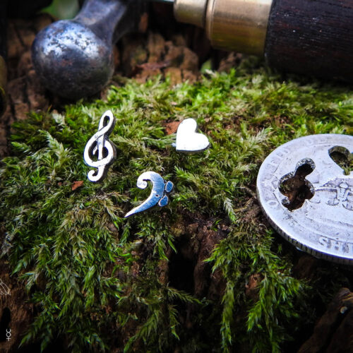 Musician earrings - handcrafted using traditional hand tools and techniques.  Handmade from recycled silver shillings.