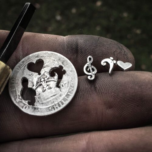 Musician earrings - handcrafted using traditional hand tools and techniques. Handmade from recycled silver shillings.