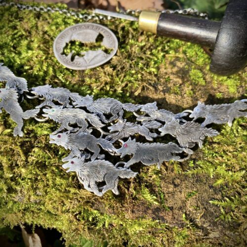 handmade ethical wolf pack silver wolves necklace made from silver coins in England. Each one is completely original