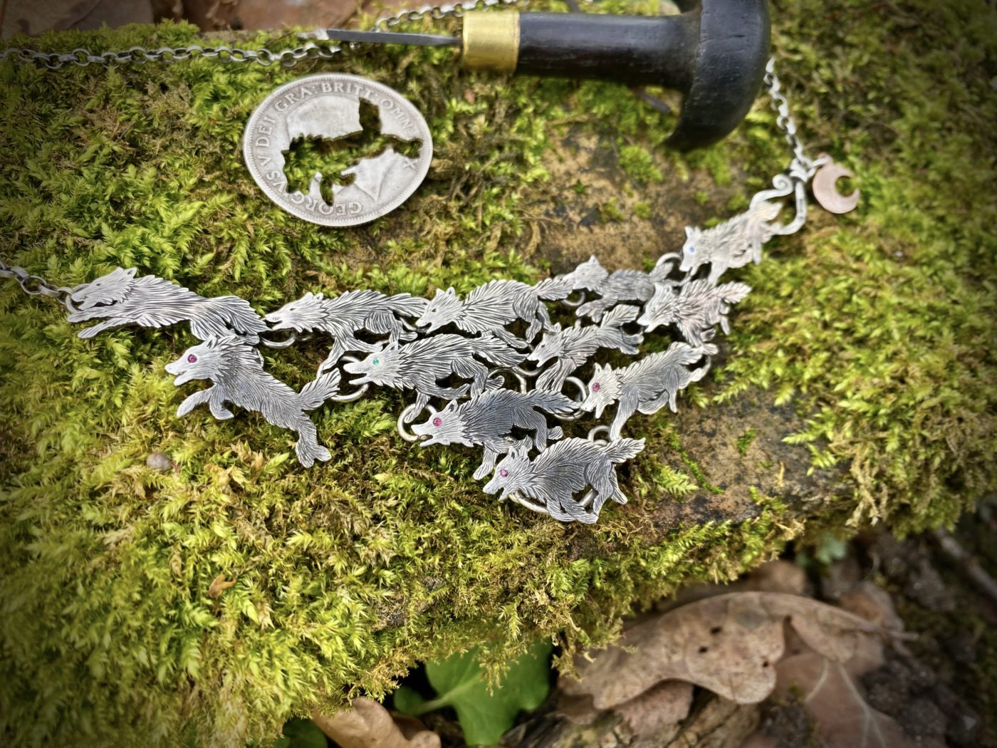 handmade ethical wolf pack silver wolves necklace made from silver coins in England. Each one is completely original
