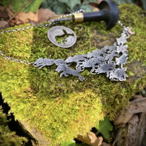 handmade ethical wolf pack silver wolves necklace made from silver coins in England. Each one is completely original