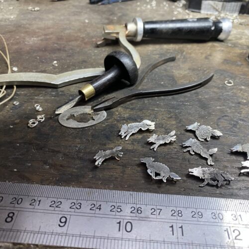 wolf pack necklace handcrafted and recycled from silver shilling coins. Made in Cambridge, England
