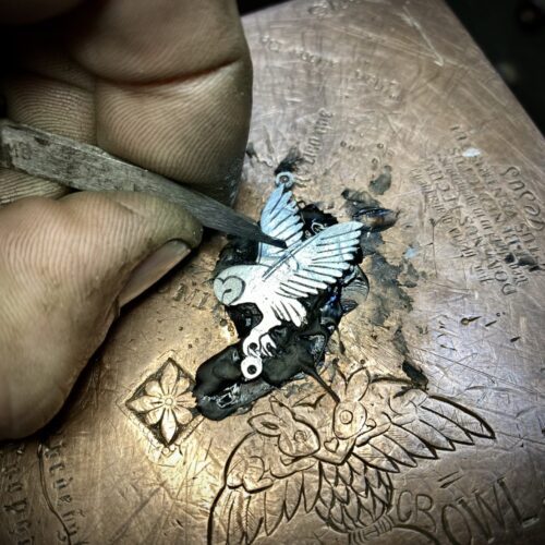handcrafted and ethical silver flying barn owl earrings pouncing on a star recycled from silver coins