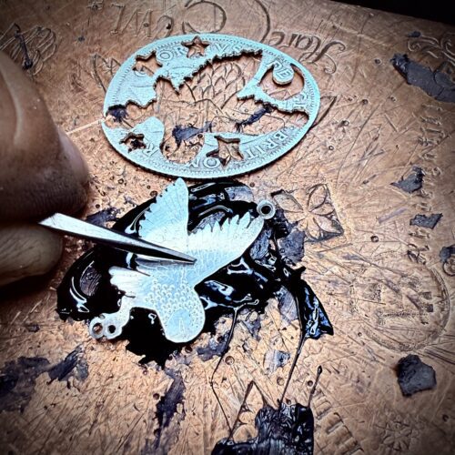 handcrafted and ethical silver flying barn owl earrings pouncing on a star recycled from silver coins