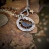 sing a song of sixpence blackbird jewellery. Handcrafted and recycled silver sixpence blackbird necklace totally handcrafted and recycled from old sterling silver sixpence coins. Designed and created by Hairy Growler Jewellery, Cambridge, UK. necklace