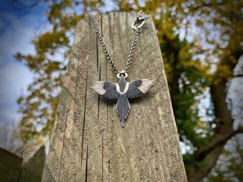 handcrafted silver Magpie necklace flying of with treasure in beak