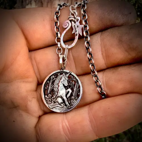 the last unicorn made from recycled silver shillings. A unique wearable artwork by Hairy Growler, Cambridge. Made in England