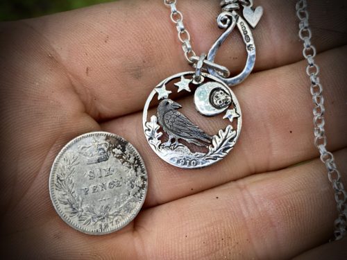 Raven jewellery. Handcrafted and recycled silver sixpence raven necklace totally handcrafted and recycled from old sterling silver sixpence coins. Designed and created by Hairy Growler Jewellery, Cambridge, UK. necklace