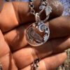 Raven jewellery. Handcrafted and recycled silver sixpence raven necklace totally handcrafted and recycled from old sterling silver sixpence coins. Designed and created by Hairy Growler Jewellery, Cambridge, UK. necklace