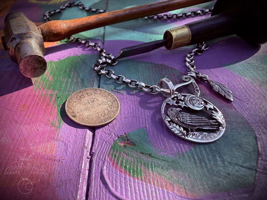 Raven jewellery. Handcrafted and recycled silver sixpence raven necklace totally handcrafted and recycled from old sterling silver sixpence coins. Designed and created by Hairy Growler Jewellery, Cambridge, UK. necklace