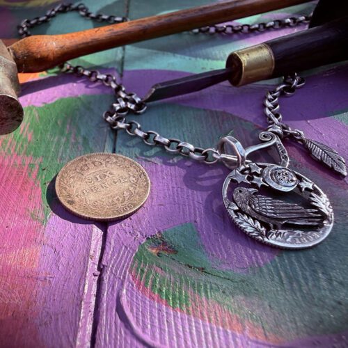 Raven jewellery. Handcrafted and recycled silver sixpence raven necklace totally handcrafted and recycled from old sterling silver sixpence coins. Designed and created by Hairy Growler Jewellery, Cambridge, UK. necklace