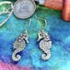 seahorse jewellery - handmade and Recycled silver shilling coin seahorses in love earrings.